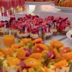 a table topped with lots of different types of desserts and drinks on top of it