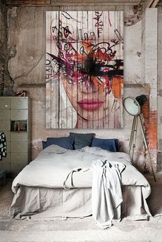 a bedroom with a large painting on the wall