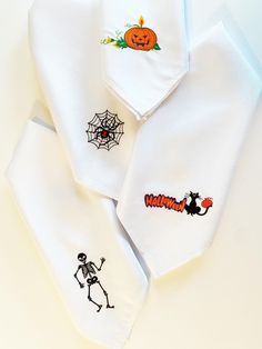 three halloween embroidered shirts on top of each other with pumpkins, spider web and jack - o'- lanterns