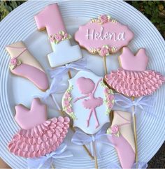 decorated cookies on a plate for a ballerina themed baby shower or first birthday party