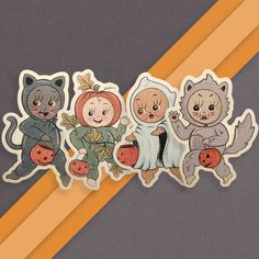 three stickers depicting children dressed up in halloween costumes and holding pumpkins, sitting next to each other