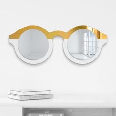 a pair of glasses sitting on top of a white table next to a book shelf