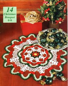 a crocheted doily is sitting on a table next to a bowl of chocolates