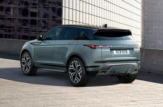 a grey range rover parked in front of a building