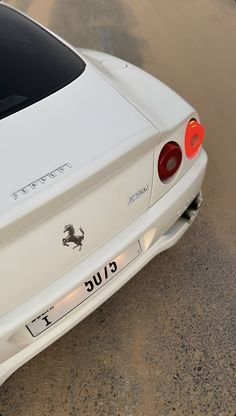 the rear end of a white sports car