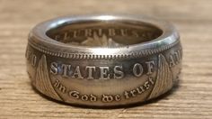 a silver coin ring with the words states of america engraved on it's side