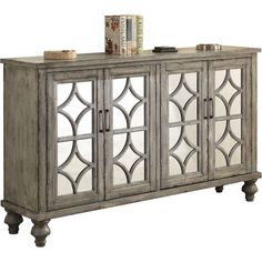 an antique style sideboard with mirrored doors and wooden legs, in grey wood finish