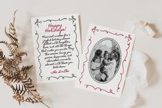 two christmas cards with the words happy holidays written on them next to some dried plants