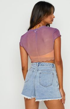 * Purple Mesh Top 
 * This sunset mesh top screams festival season ()! Pair with denim shorts () and Dr Martens () for the perfect fit.  
 * Short sleeves 
 * Baby tee style 
 * Cropped length 
 * Unlined - sheer 
 * Lettuce hem on sleeve and hem 
 * Crew neck 
 * Ombre style colouring of purple and orange tint Sunset Purple, All Aesthetics, Summer Bottoms, Prom Midi Dress, Summer Playsuit, Ombre Fashion, Crochet Sandals, Lettuce Hem, Purple And Orange