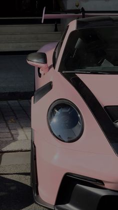 the front end of a pink sports car