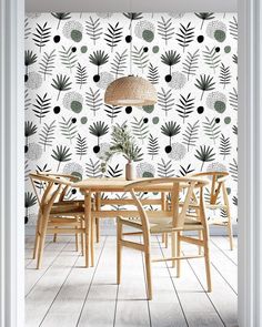 a dining room with a table and chairs in front of a wallpapered background