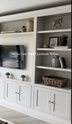 a white entertainment center with built in bookshelves