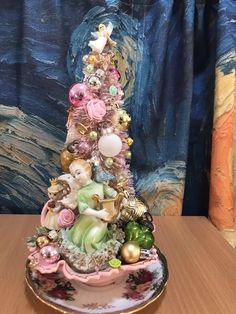 a small christmas tree made out of porcelain figurines