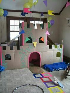 a castle made out of cardboard with balloons