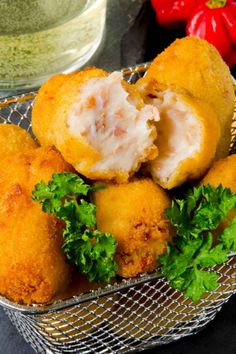 some fried food in a metal basket on a table