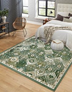 a bedroom with a large green rug on the floor