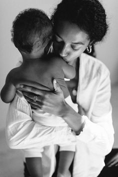 a woman holding a baby in her arms