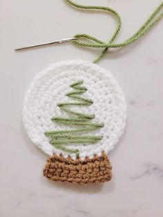 a crocheted ornament with a christmas tree on it