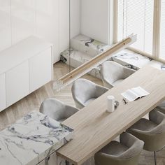 an overhead view of a dining room table and chairs with marbled counter tops in the center