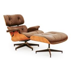 an eames lounge chair and ottoman with brown leather upholstered on the back