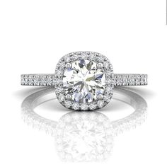 a diamond engagement ring with diamonds surrounding it