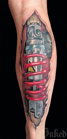 a man's leg with a tattoo on it that has a car engine in the middle