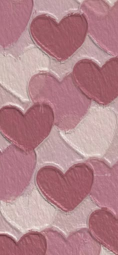 pink and white hearts are arranged in the shape of heart shapes on a textured paper background