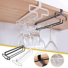 three wine glasses are hanging from the ceiling and one glass holder is holding two wine glasses