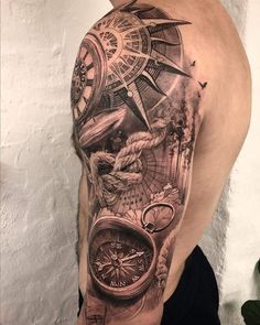 a man's half sleeve with a clock, compass and other things on it