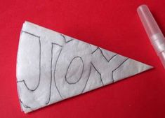 a piece of paper with the word joy written on it and a marker next to it