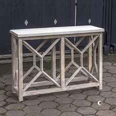 a wooden table sitting on top of a stone floor