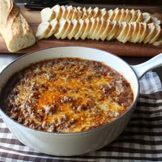 a bowl of chili with bread on the side