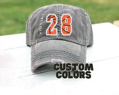 a gray hat with orange numbers on it