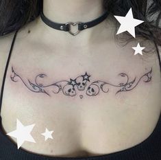 a woman's chest with skulls and stars on it