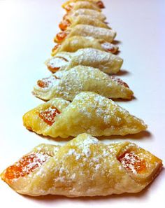 several pastries lined up on a white surface