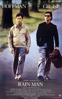 two men walking down the street in front of trees and grass, one is carrying a briefcase