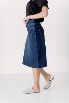 Simple lines, classic and comfortable, the 'Sara' is everything a denim skirt should be. Wide waistband for extra comfort and ease of styling. Exclusively designed by us for you. 95% Cotton/ 5% Spandex Machine Wash Cold, Tumble Dry Low Functional Back Pockets Available in both 21" ,24", and 26" length   Model Height: 5'8 | Wearing size 2 in 26" Length Dark Wash Stretch Skirt With Straight Leg, Dark Wash Straight Leg Stretch Skirt, Dark Wash Mid-rise Denim Skirt, Classic Medium Wash Mid-rise Denim Skirt, Classic Mid-rise Medium Wash Denim Skirt, Dark Wash High Rise Relaxed Fit Skirt, Classic Mid-rise Denim Blue Denim Skirt, Classic Mid-rise Denim Blue Skirt, Classic Denim Blue Denim Skirt