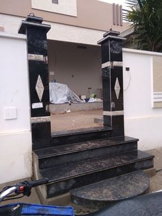 a mirror sitting on the side of a building next to some steps and a bike