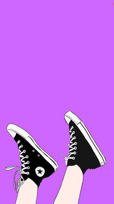 a person's feet with black and white converse shoes on them, against a purple background