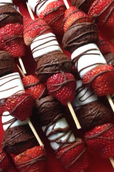 chocolate covered strawberries are arranged on skewers