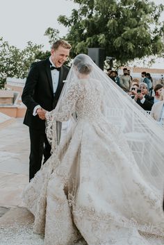 a bride and groom walking down the aisle