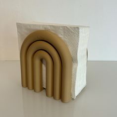 a set of four brown napkin holders sitting on top of a table