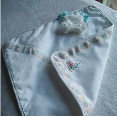 a baby bib laying on top of a bed