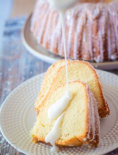 a bundt cake is being drizzled with icing on a plate