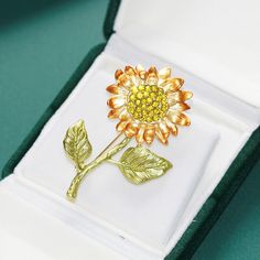 This elegant Sunflower flower brooch adds a touch of nature to any outfit. Made with stunning detail and craftsmanship, this brooch is a versatile accessory that can be worn on clothing, hats, bags, and more. The perfect addition to your collection or as a gift for someone special.

Size: 55*37mm
Weight about: 10.24g
High quality zinc alloy
Hypoallergenic, lead and nickel free

*We carefully select each stone to provide the best quality stones. Since the stones are natural materials, the stone c Someone Special, Flower Brooch, Natural Materials, Zinc Alloy, Free Gifts, Sunflower, Gift Box, Stone, Yellow