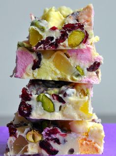 a stack of fruit and nut bars sitting on top of a purple surface