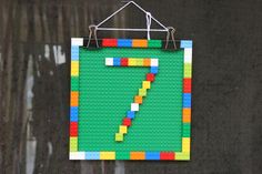 a piece of lego art hanging on a wall