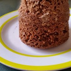 a chocolate cake sitting on top of a white and yellow plate