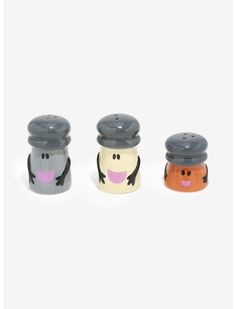 three salt and pepper shakers in the shape of cartoon characters with faces on them