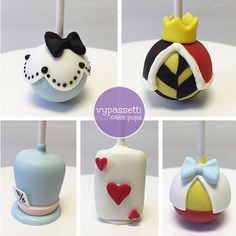 four different cake pops decorated with fondant designs